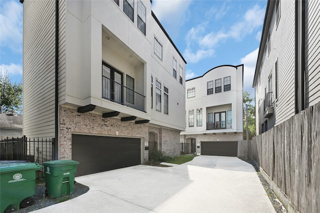 view of front of house featuring a balcony and a garage