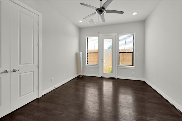 spare room featuring ceiling fan and dark hardwood / wood-style flooring