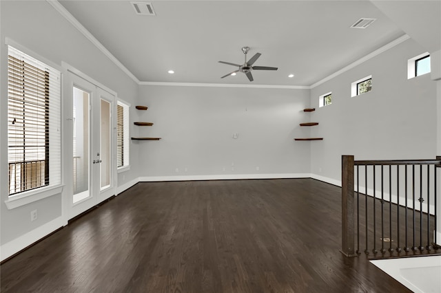 spare room featuring crown molding, dark hardwood / wood-style floors, and plenty of natural light