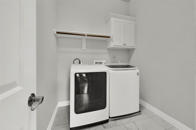 laundry room featuring cabinets and separate washer and dryer