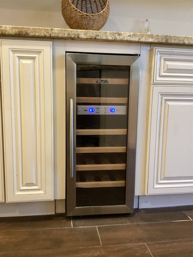 room details with hardwood / wood-style floors and beverage cooler