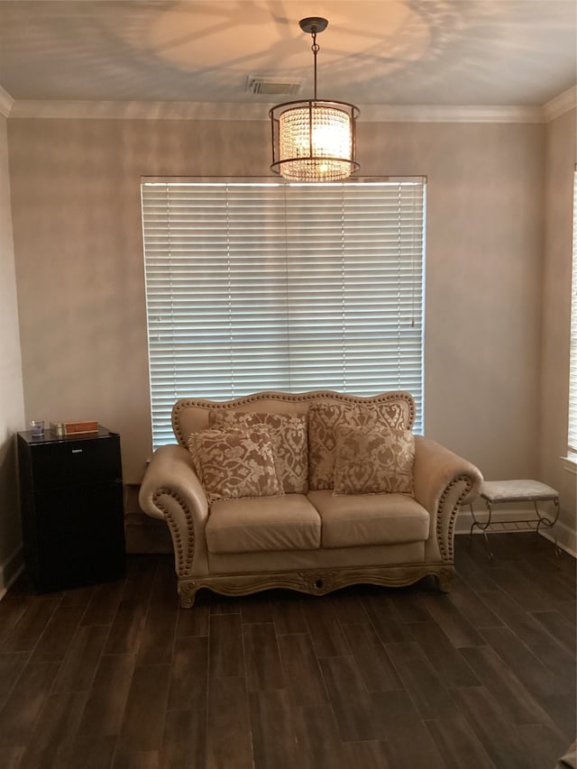 living room with ornamental molding, a chandelier, and dark hardwood / wood-style flooring