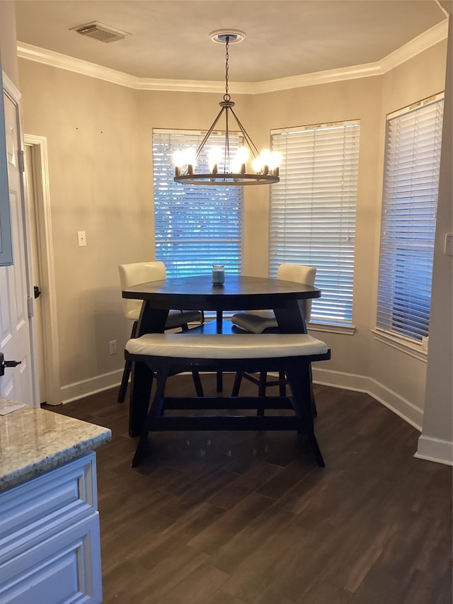 dining space with an inviting chandelier, crown molding, dark hardwood / wood-style floors, and a wealth of natural light