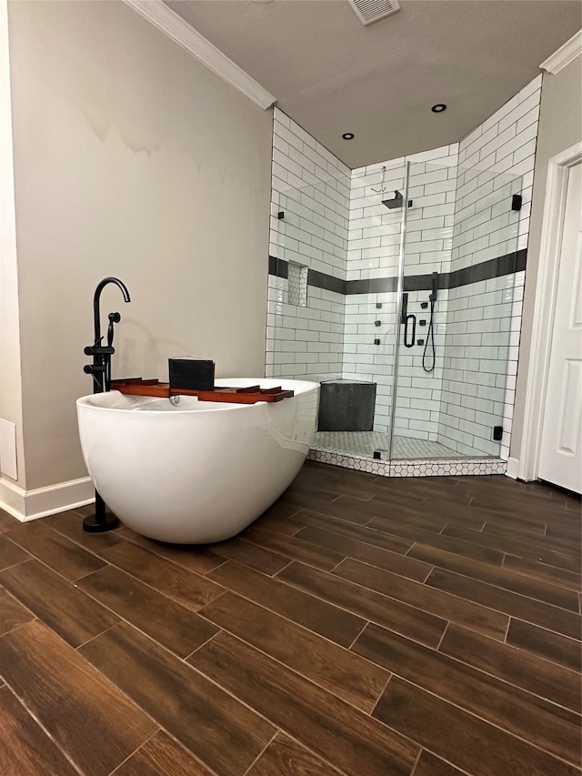 bathroom with ornamental molding and plus walk in shower