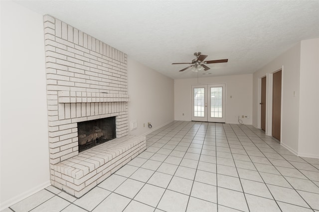 unfurnished living room with light tile patterned flooring, a fireplace, french doors, a textured ceiling, and ceiling fan