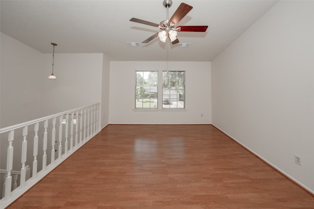 spare room with ceiling fan and hardwood / wood-style flooring