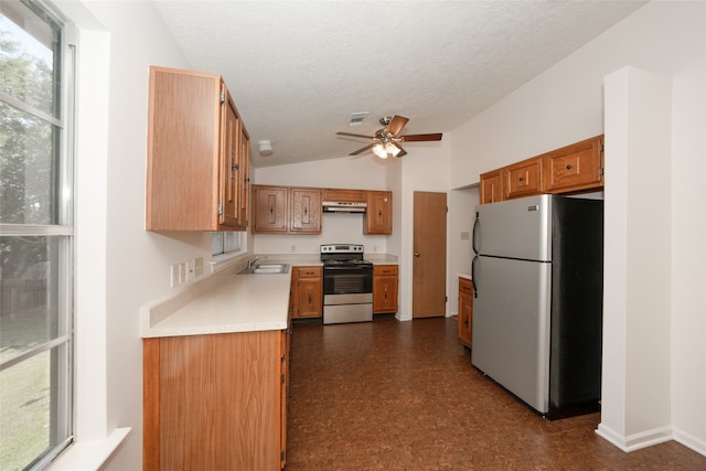 kitchen with ceiling fan, a textured ceiling, vaulted ceiling, sink, and stainless steel appliances