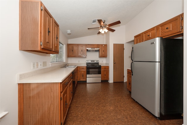 kitchen featuring ceiling fan, appliances with stainless steel finishes, a textured ceiling, vaulted ceiling, and sink