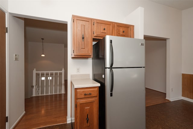 kitchen featuring dark hardwood / wood-style flooring and stainless steel refrigerator