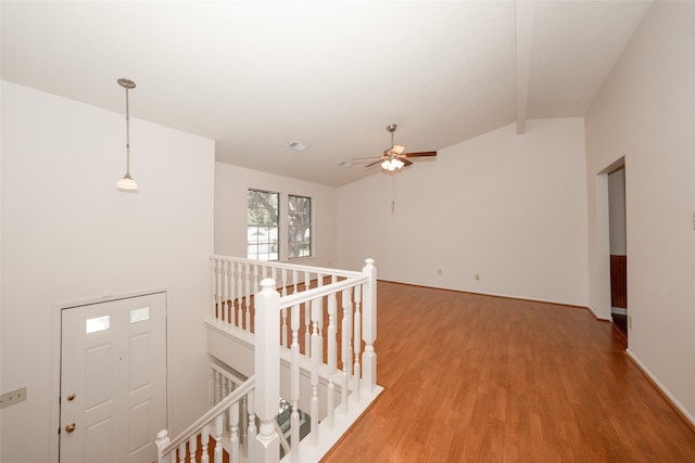 hallway with hardwood / wood-style flooring and lofted ceiling