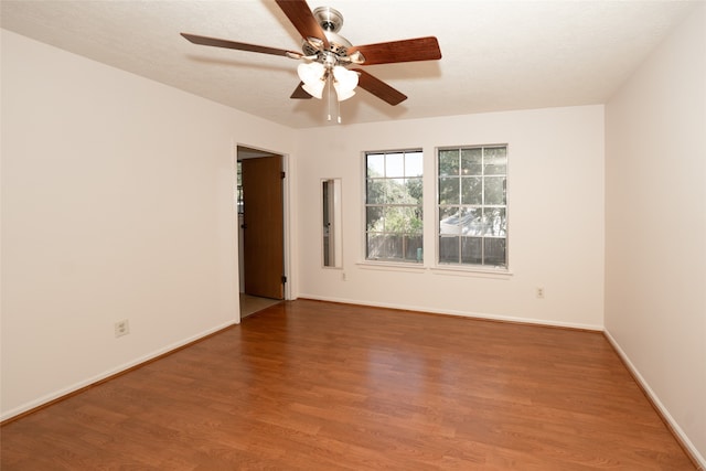 spare room featuring hardwood / wood-style flooring and ceiling fan