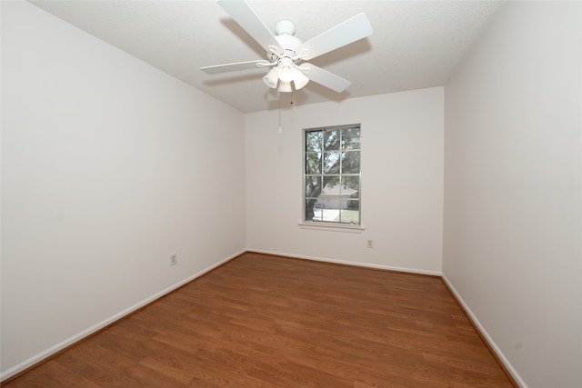 spare room with hardwood / wood-style floors and ceiling fan