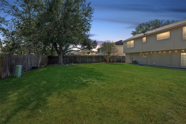 yard at dusk featuring cooling unit