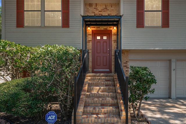 view of exterior entry with a garage