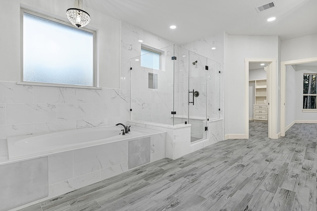 bathroom with plus walk in shower and wood-type flooring