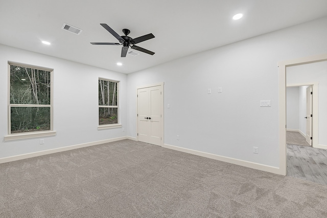 empty room with light carpet and ceiling fan