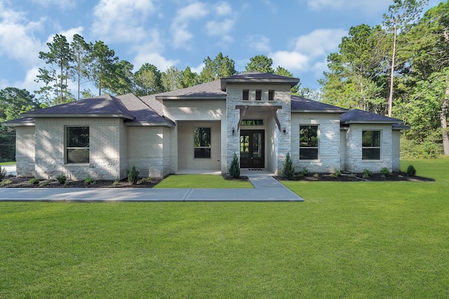 prairie-style home featuring a front yard