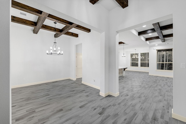 unfurnished living room featuring coffered ceiling, hardwood / wood-style flooring, and beamed ceiling