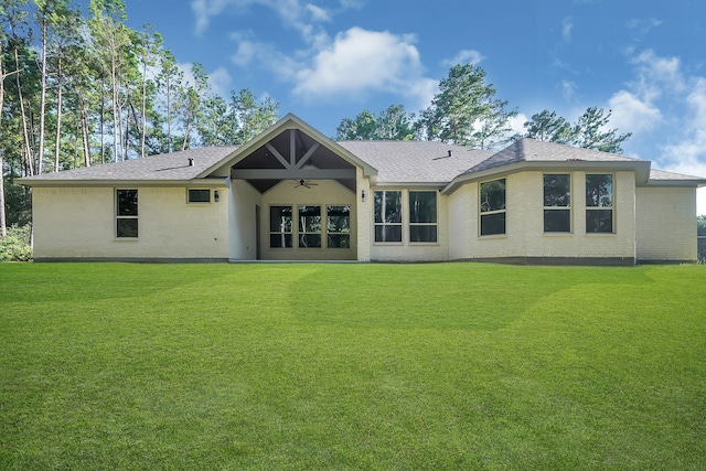 back of house with a yard and ceiling fan