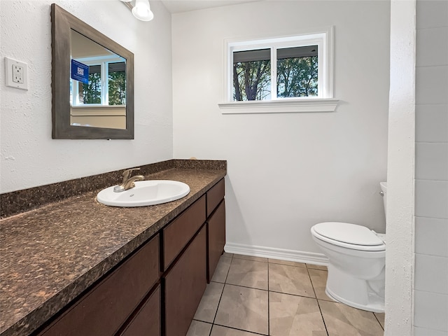 bathroom featuring vanity, toilet, and tile patterned floors