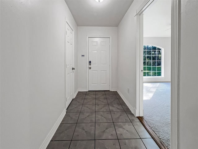 doorway featuring dark colored carpet