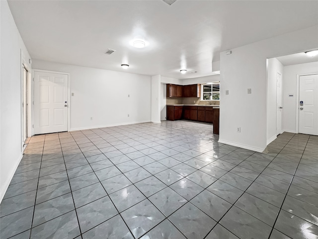 unfurnished living room with light tile patterned flooring