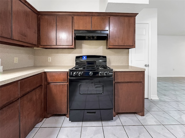 kitchen featuring light tile patterned floors, ventilation hood, black gas range oven, and tasteful backsplash