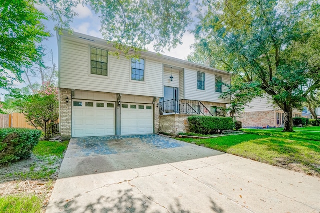 split foyer home with a front yard and a garage