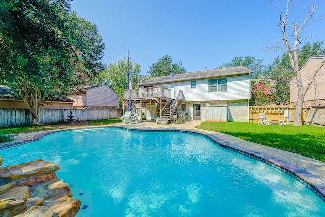 view of pool featuring a yard and a deck