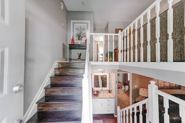 stairs featuring hardwood / wood-style flooring