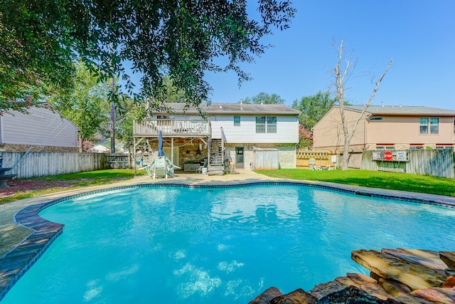 view of swimming pool featuring a patio area, a deck, and a lawn