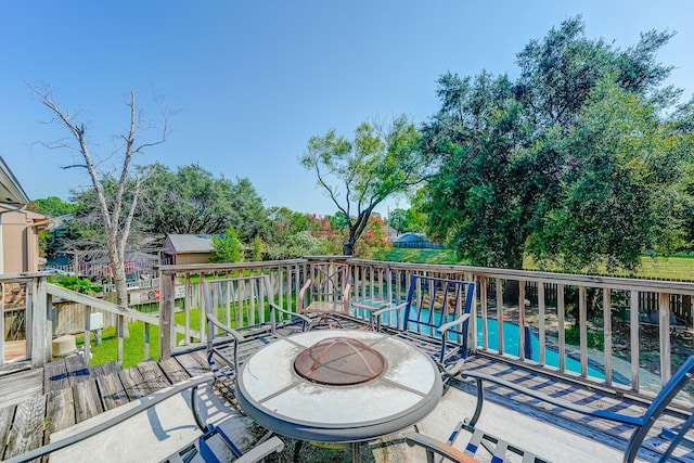 exterior space with a deck and an outdoor fire pit