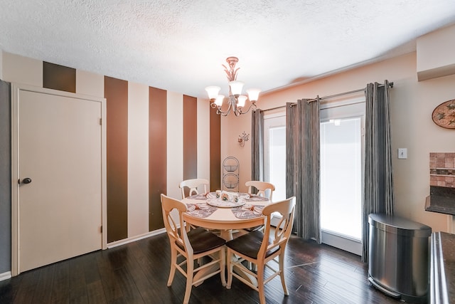 dining room featuring dark wood-type flooring, a notable chandelier, and plenty of natural light