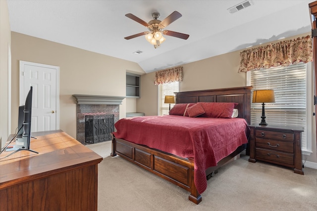 bedroom with lofted ceiling, light colored carpet, and ceiling fan