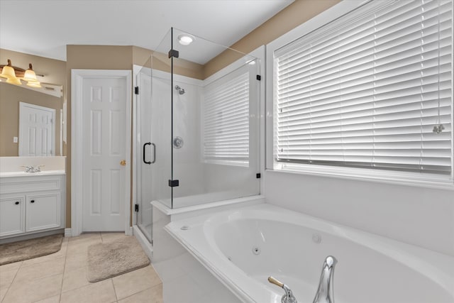 bathroom featuring vanity, a healthy amount of sunlight, tile patterned floors, and separate shower and tub