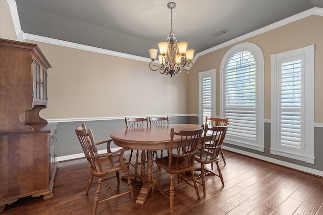 dining room featuring ornamental molding, a chandelier, and dark hardwood / wood-style flooring