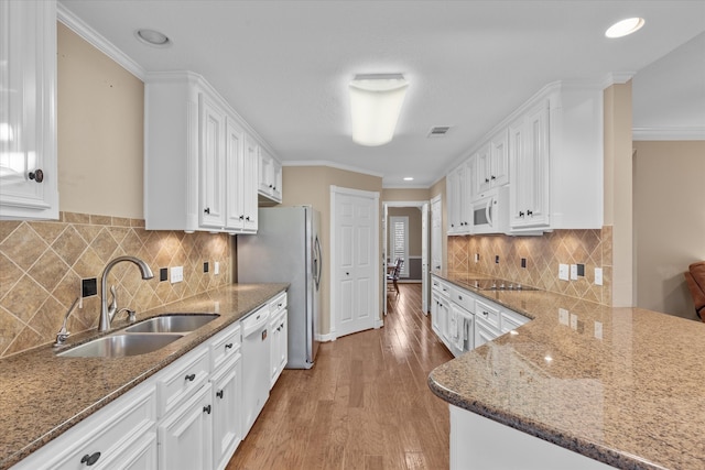 kitchen with white appliances, sink, light wood-type flooring, white cabinetry, and crown molding