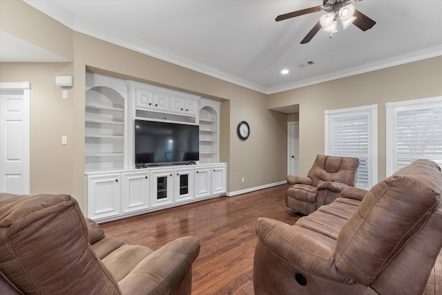 living room with dark wood-type flooring, crown molding, built in features, and ceiling fan