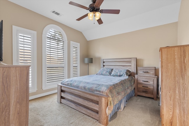 bedroom featuring vaulted ceiling, light carpet, and ceiling fan