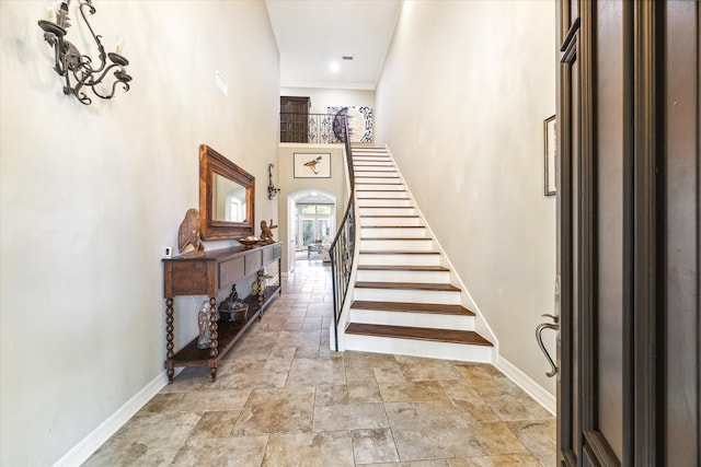 foyer entrance featuring ornamental molding and a high ceiling