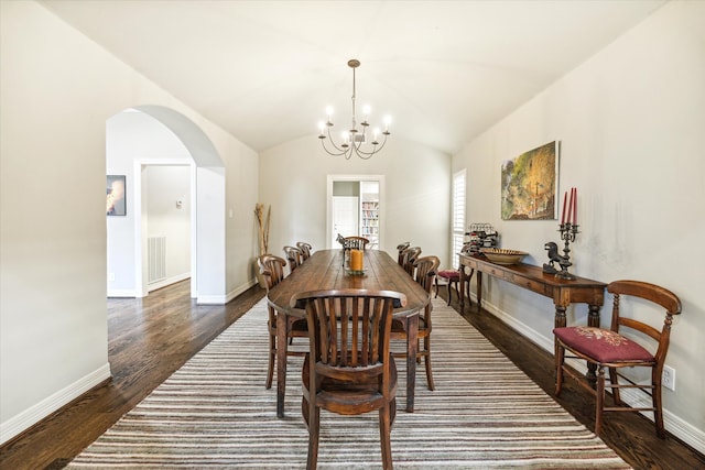 dining area featuring vaulted ceiling, an inviting chandelier, and dark hardwood / wood-style flooring