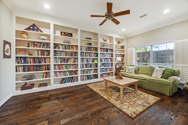 living area featuring ceiling fan, built in features, ornamental molding, and dark hardwood / wood-style floors