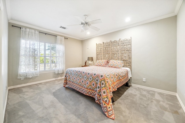 carpeted bedroom featuring crown molding and ceiling fan