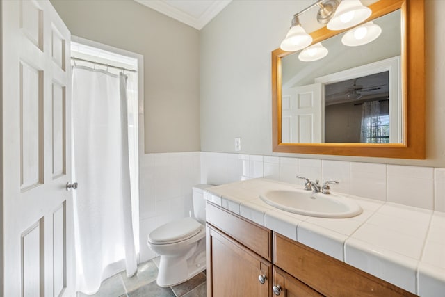 bathroom with toilet, crown molding, vanity, and tile patterned flooring