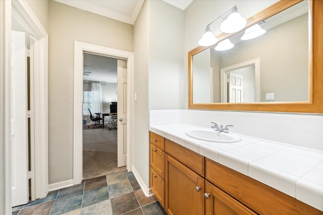 bathroom featuring vanity, ornamental molding, and tasteful backsplash