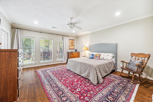 bedroom featuring ornamental molding, a textured ceiling, dark hardwood / wood-style floors, and ceiling fan