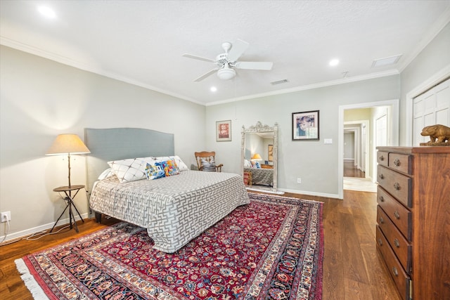 bedroom with crown molding, dark hardwood / wood-style floors, and ceiling fan