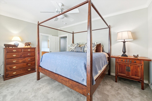 carpeted bedroom featuring ornamental molding and ceiling fan