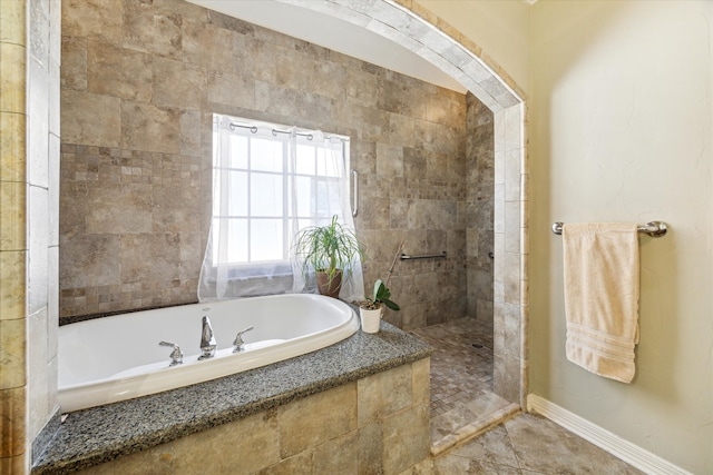 bathroom featuring separate shower and tub