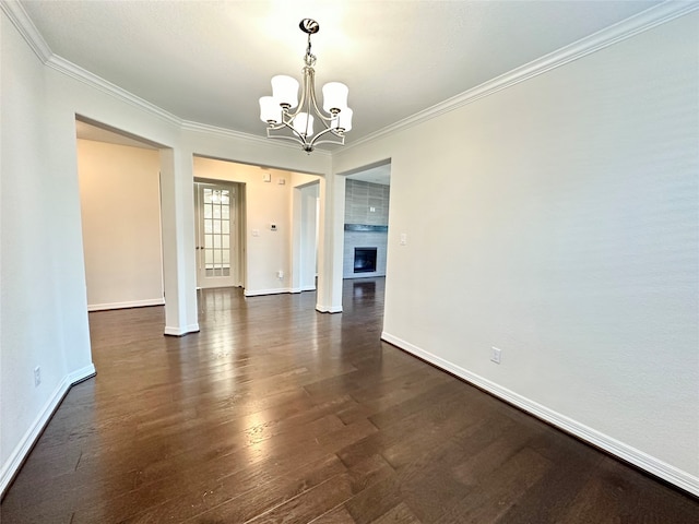 unfurnished dining area featuring ornamental molding, a notable chandelier, and dark hardwood / wood-style flooring